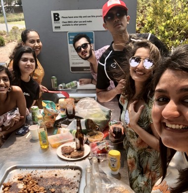 A group of students enjoying a BBQ in the park.