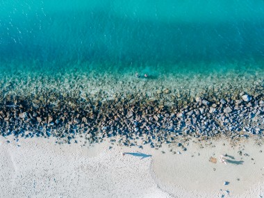 Overhead drone image of the gorgeous aqua blue waters and white sand of Tallebugdera Creek